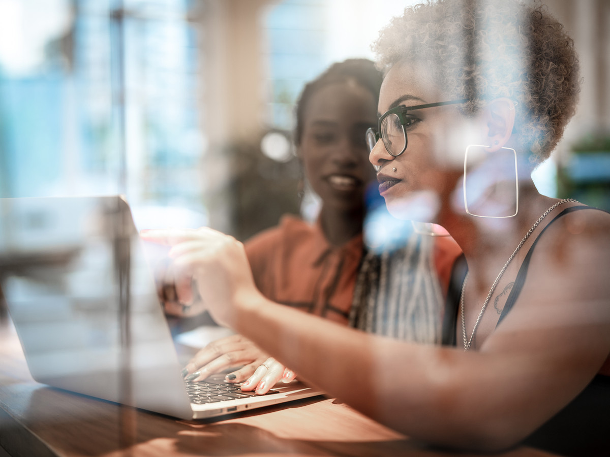 Copywriter Nat Milligan. 3 ways to crush it as a copywriter today. Two women working together on a laptop.