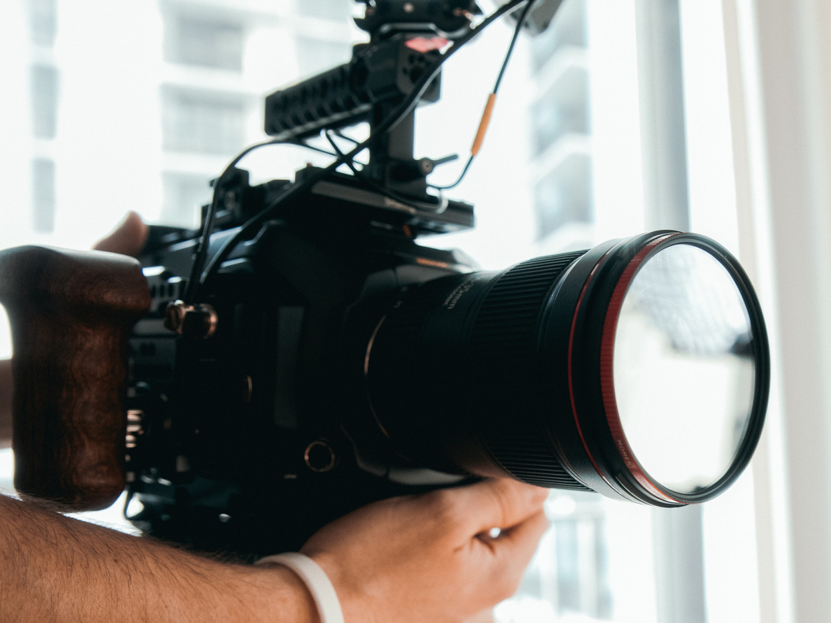 hands holding a camera filming