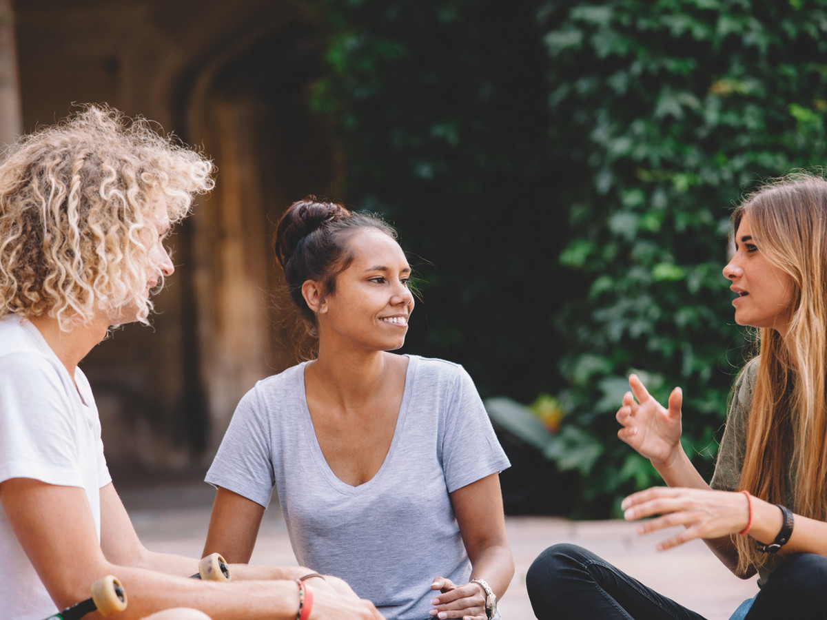three friends chatting outdoors